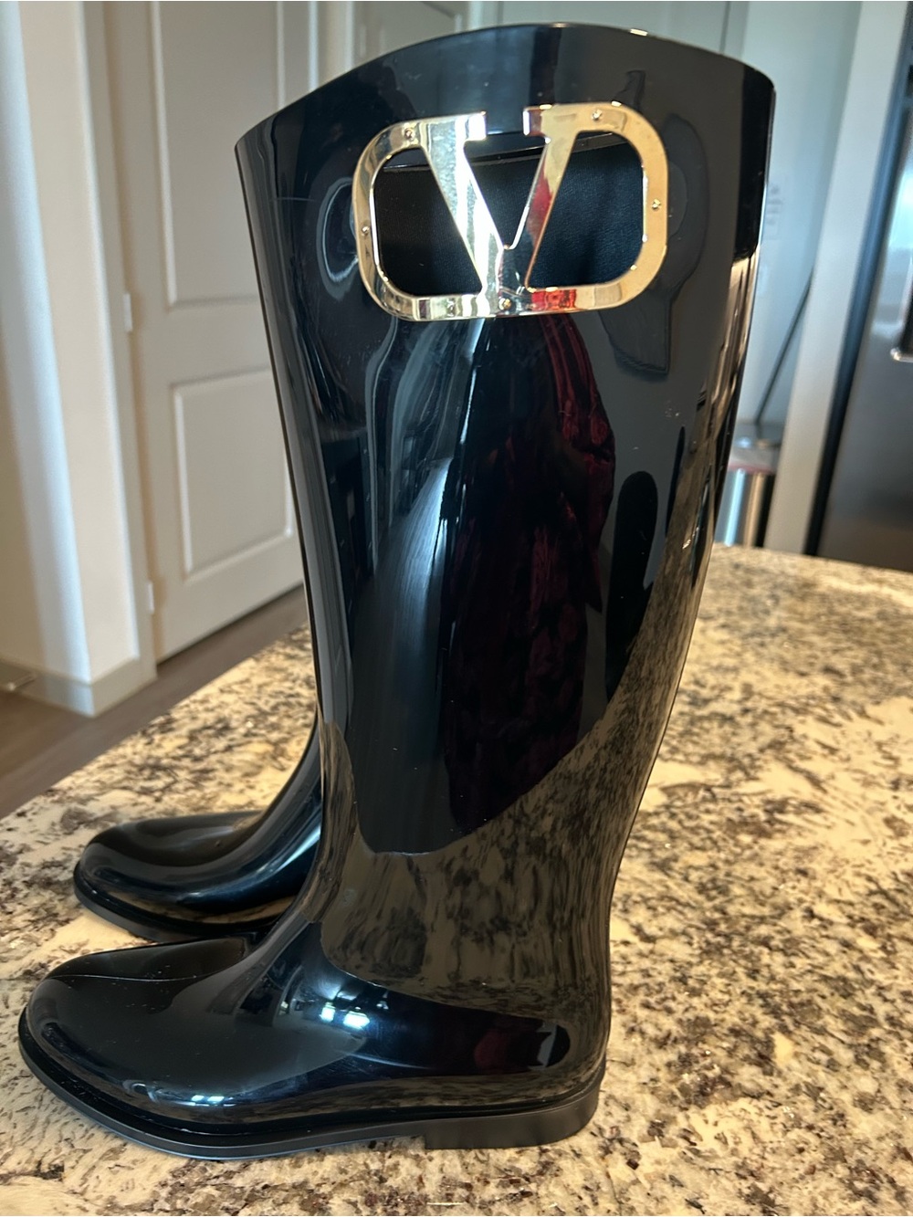 Valentino Glossy Black Knee-High Boots with Gold Logo Plaque